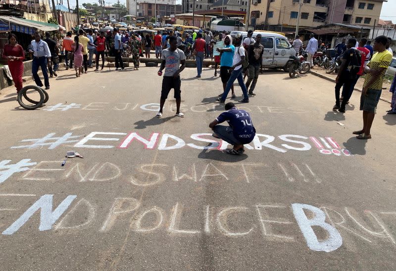 A demonstrator paints 'End Sars' during a protest demanding police reform in Lagos