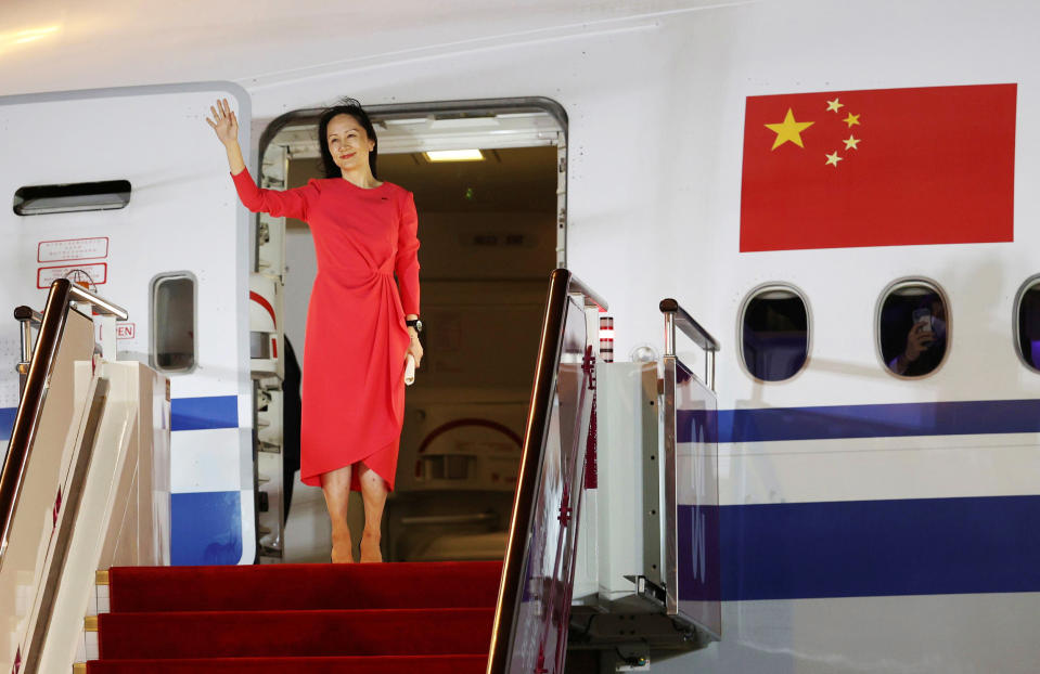 Image: Meng waves as she steps out of a airplane at Shenzhen Baoan International Airport in Shenzhen (Jin Liwang / Xinhua via Reuters)