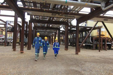 Groundbirch Operations Manager Wouter de Klein, General Manager Rej Tetrault and an employee walk through the Shell Canada's Saturn gas plant at the Groundbirch project in Groundbirch, British Columbia, Canada, October 11, 2018.  REUTERS/Julie Gordon