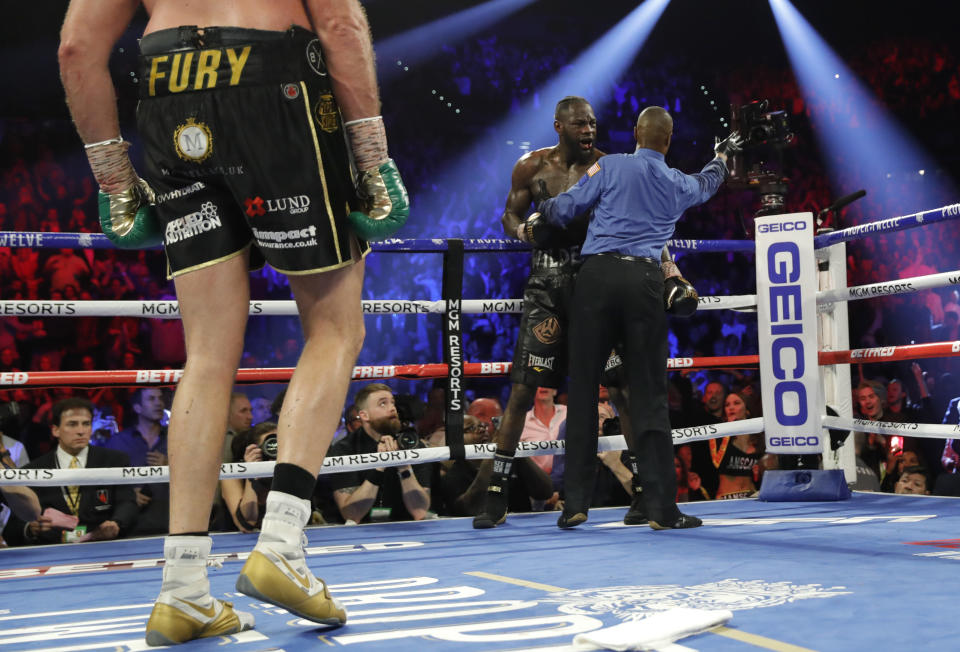 Boxing - Deontay Wilder v Tyson Fury - WBC Heavyweight Title - The Grand Garden Arena at MGM Grand, Las Vegas, United States - February 22, 2020 Deontay Wilder is spoken to by Referee Kenny Bayless during his fight with Tyson Fury as the towel is thrown into the ring from Wilder's corner resulting in Fury winning the fight REUTERS/Steve Marcus