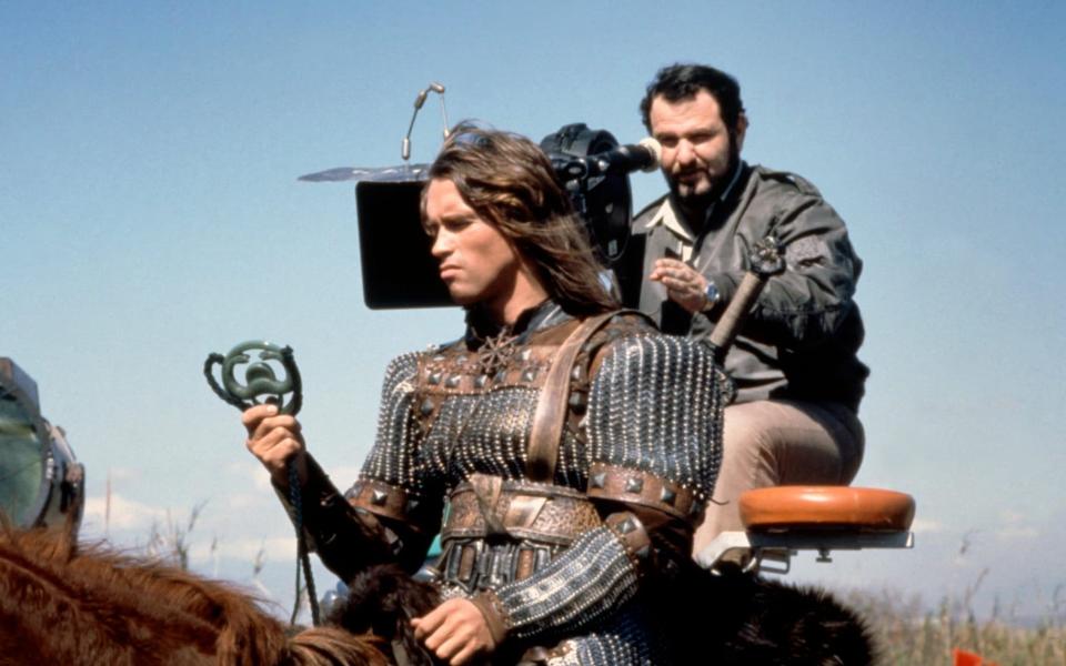 Arnold Schwarzenegger with director John Millius on the set of Conan the Barbarian - Alamy