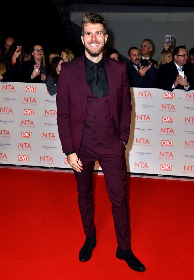 Joel Dommett smiling on a red carpet