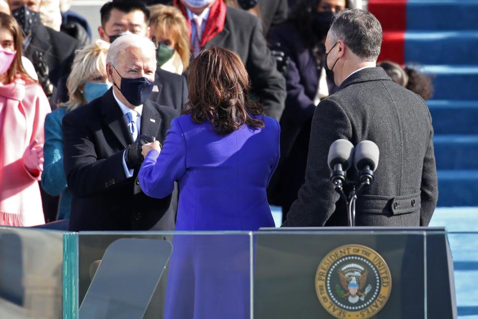 <p>Joe Biden fist bumps his Vice President, Kamala Harris, after she is sworn in. </p>