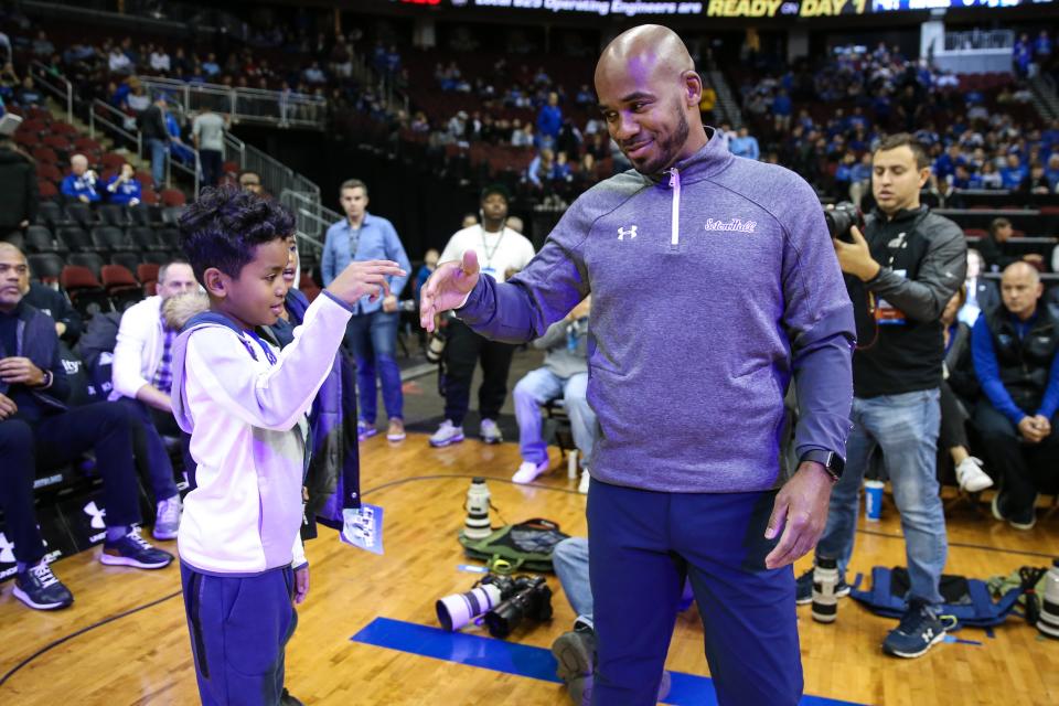 Seton Hall Pirates head coach Shaheen Holloway greets his son prior to the game against the Iowa Hawkeyes