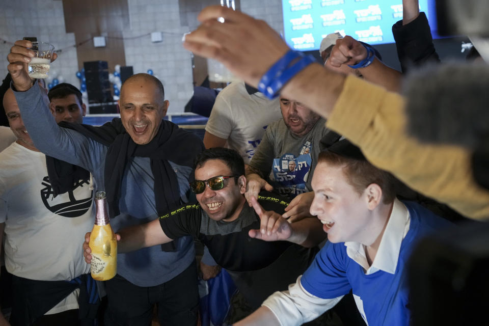 Supporters of Benjamin Netanyahu, former Israeli Prime Minister and the head of Likud party celebrates the first exit poll results for Israel's election, at the Likud party headquarters in Jerusalem, Tuesday, Nov. 1, 2022. (AP Photo/Maya Alleruzzo)