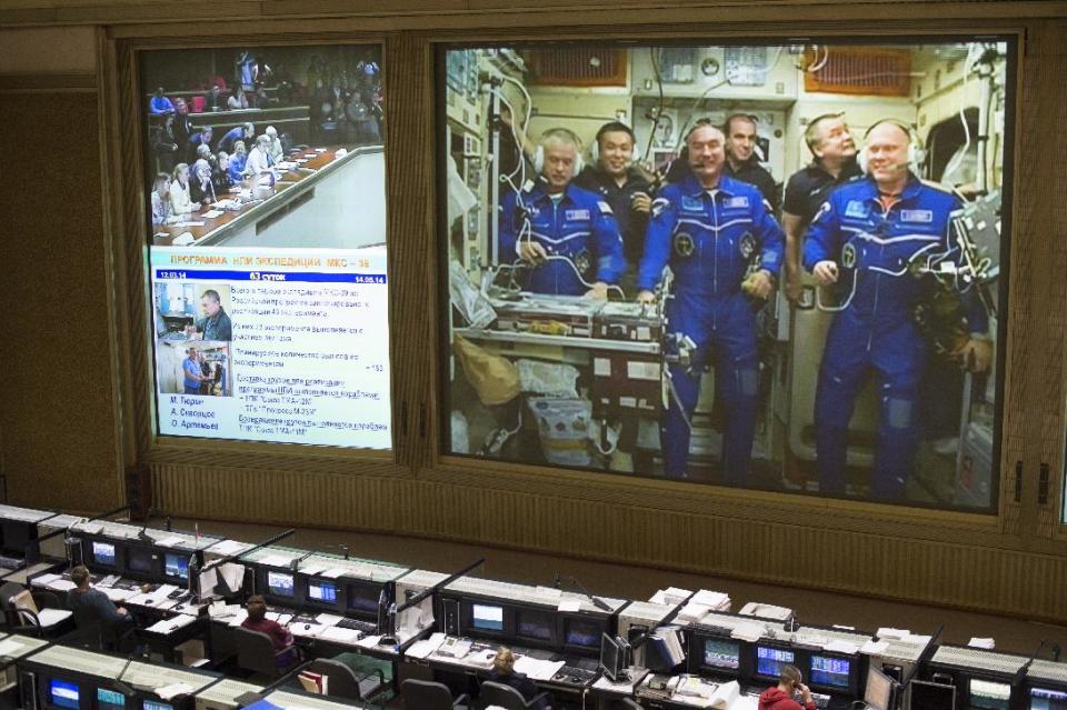 In this image provided by NASA shows a view from the balcony of the Russian Mission Control Center shows live television of the Expedition 39 crew members gathered together on the International Space Station a few hours after the Soyuz TMA-12M spacecraft docked on Friday, March 28, 2014, in Korolev, Russia. Pictured are Expedition 39 crew members Flight Engineer Steve Swanson of NASA, left, Commander Koichi Wakata of the Japan Aerospace Exploration Agency, JAXA, back left, Flight Engineer Alexander Skvortsov of the Russian Federal Space Agency, Roscosmos, front center, Flight Engineer Rick Mastracchio of NASA, back center, Flight Engineer Mikhail Tyurin of Roscosmos, back right and Flight Engineer Oleg Artemyev of Roscosmos, front right. Swanson, Skvortsov, and Oleg's arrival to the International Space Station comes two days after they launched from the Baikonur Cosmodrome in Kazakhstan. Photo Credit (NASA/Joel Kowsky)