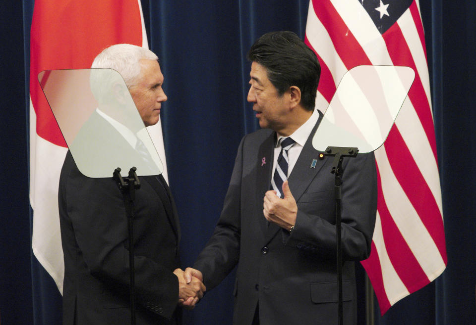 U.S. Vice President Mike Pence, left, and Japanese Prime Minister Shinzo Abe shake hands after they read a joint statement at Abe's official residence in Tokyo Tuesday, Nov. 13, 2018. (AP Photo/Eugene Hoshiko)