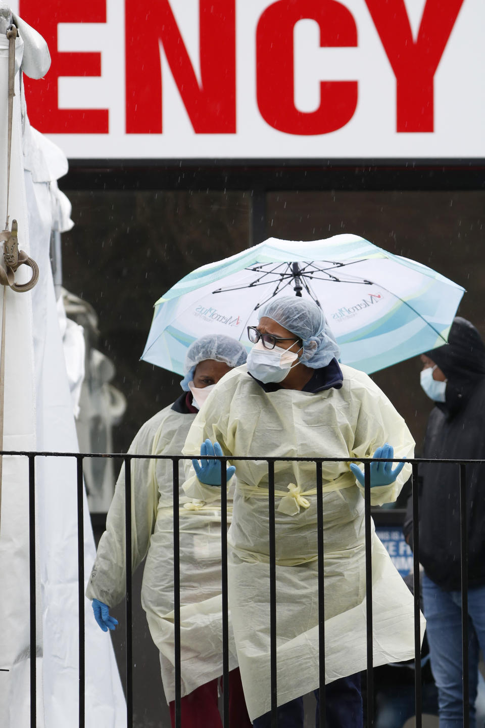 A medical worker checks to see if anyone is waiting in line outside a COVID-19 testing tent at Elmhurst Hospital Center in New York, Saturday, March 28, 2020. The hospital is caring for a high number of coronavirus patients in the city. (AP Photo/Kathy Willens)