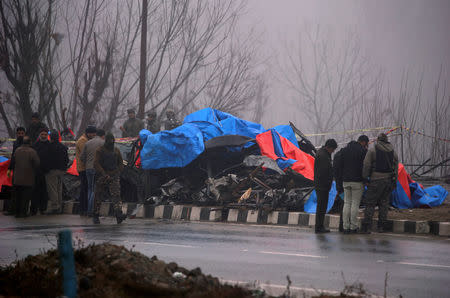 FILE PHOTO: Forensic officials inspect the wreckage of a bus after a suicide bomber rammed a car into the bus carrying Central Reserve Police Force (CRPF) personnel on Thursday, in Lethpora in south Kashmir's Pulwama district, February 15, 2019. REUTERS/Danish Ismail/File Photo