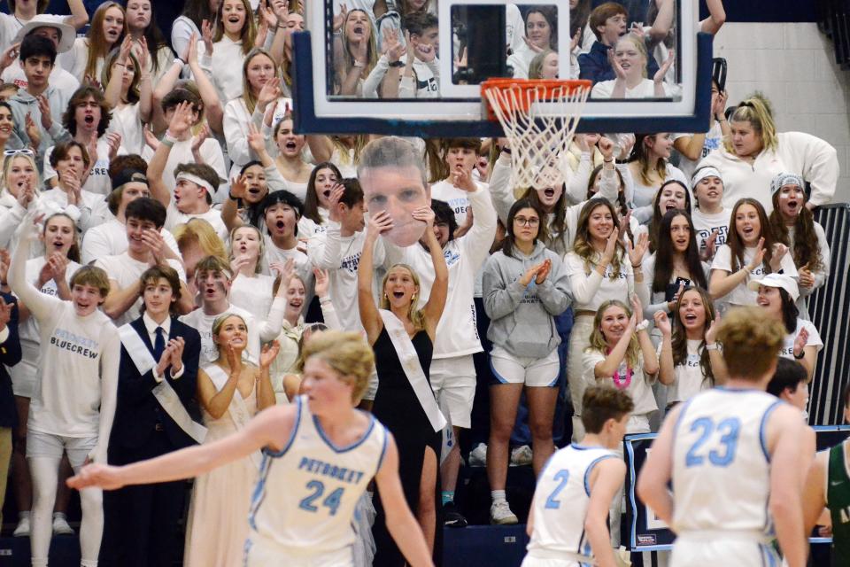 The Petoskey blue crew student section celebrates a first half 3-pointer during Friday's home win over Alpena.