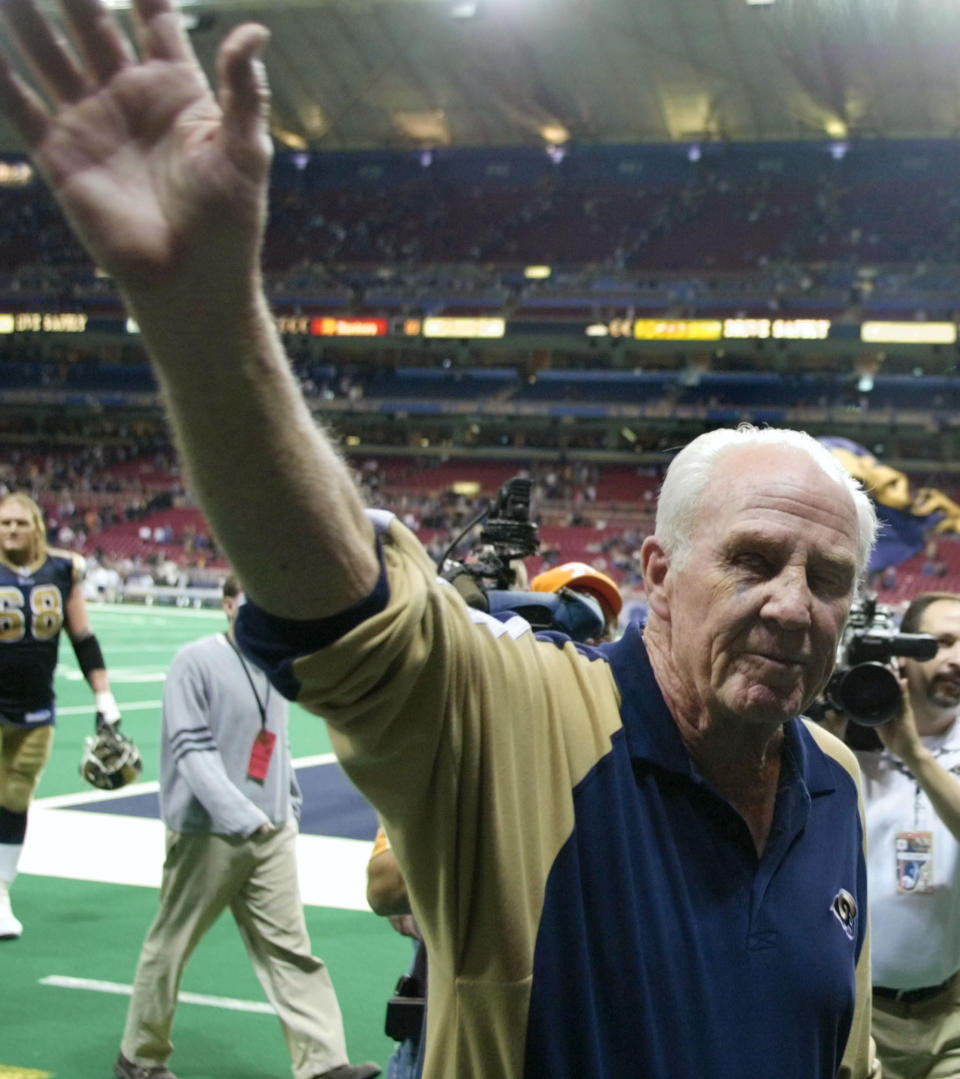 FILE - In this Dec. 21, 2003, file photo, St. Louis Rams defensive line coach Jim Hanifan waives goodbye to the crowd after the team's NFL football game against the Cincinnati Bengals in St. Louis. Hanifan retired after 31 years of coaching in the league. Hanifan, the former St. Louis Cardinals coach who returned to the city as offensive line coach to help the Rams win the Super Bowl, has died. He was 87. Hanifan’s daughter, Kathy Hinder, told the St. Louis Post-Dispatch that he died Tuesday, Nov. 24, 2020. She said the cause of death hasn't been determined, but said it wasn't related to COVID-19. (AP Photo/Tom Gannam, File)