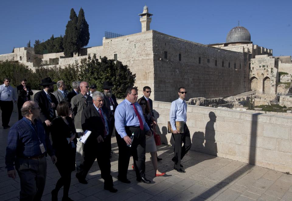 Backdropped by the Al Aqsa Mosque compound New Jersey Gov. Chris Christie, third from the right, walks during his visit to Jerusalem's old city Monday, April 2, 2012. Christie kicked off his first official overseas trip Monday meeting Israel's leader in a visit that may boost the rising Republican star's foreign policy credentials ahead of November's presidential election. (AP Photo/Sebastian Scheiner)