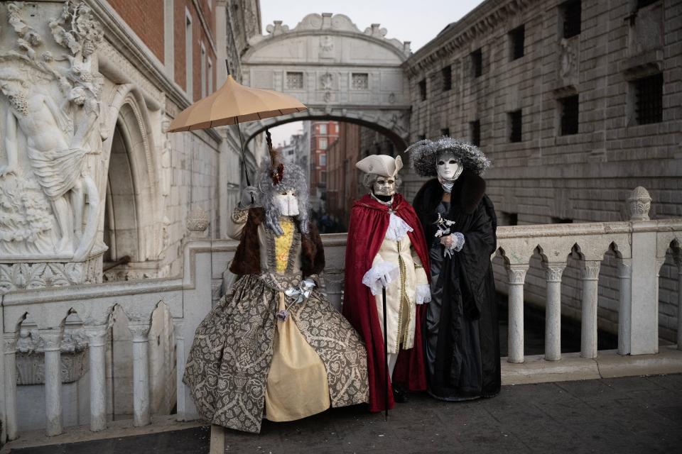 Masked revellers wearing period costumes pose during the traditional Venice Carnival, on February 4, 2024.