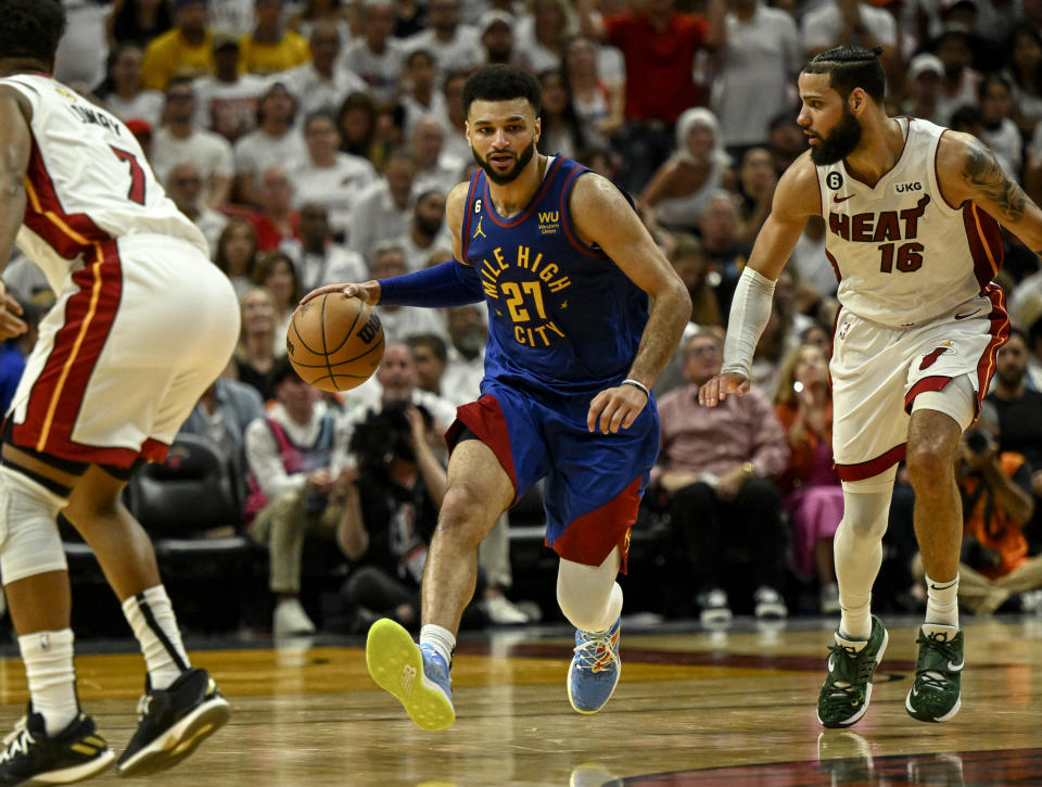 Denver Nuggets' Jamal Murray handles the ball as Miami Heat's Caleb Martin defends during Game 3 of the NBA Finals at Kaseya Center in Miami on June 7, 2023. (AAron Ontiveroz/The Denver Post)