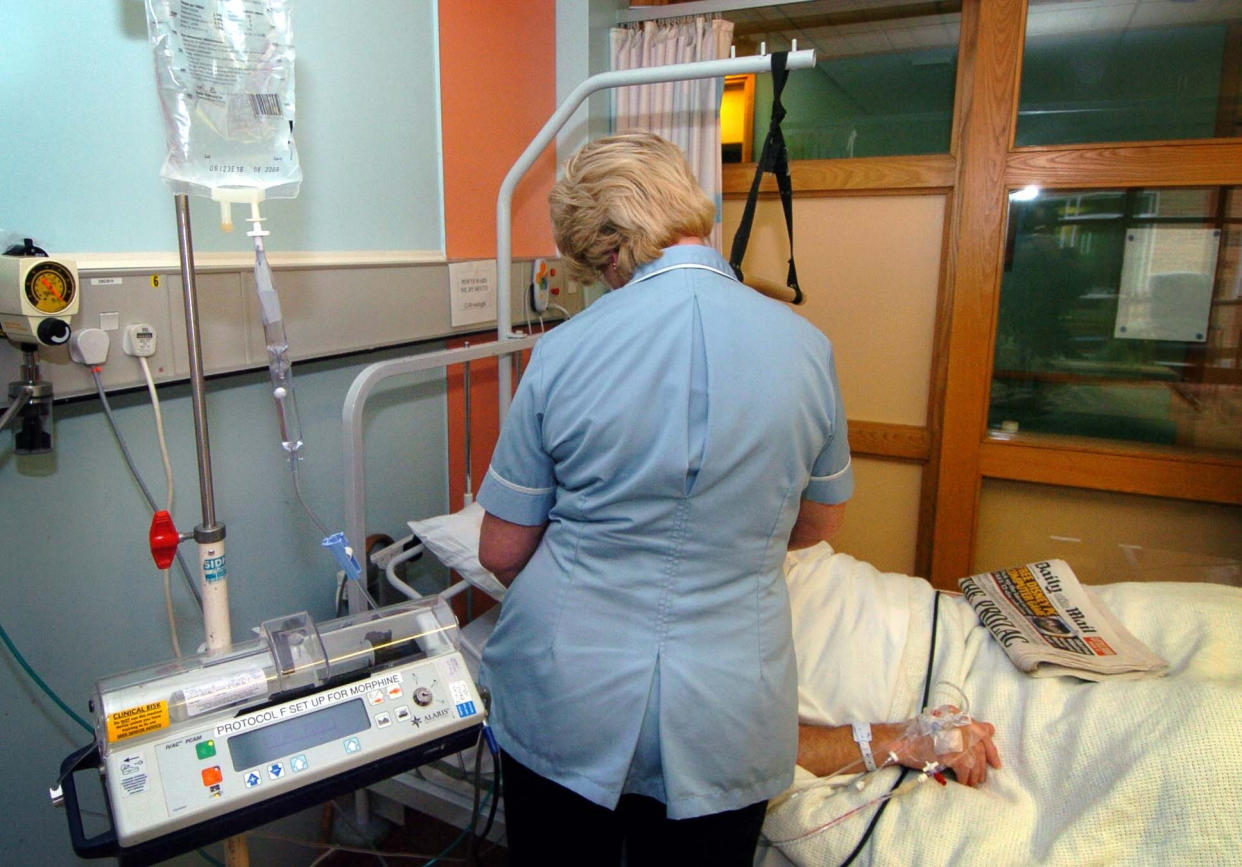 Embargoed to 0001 Thursday November 28 Undated file photo of a nurse treating a patient. The NHS is relying on less qualified staff to plug workforce gaps due to a huge shortage of nurses, a new report says.