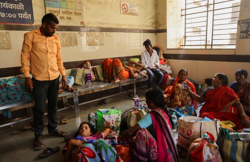 Relatives of patients admitted at the Shankarrao Chavan Government Medical College and Hospital are seen inside the hospital, in Nanded