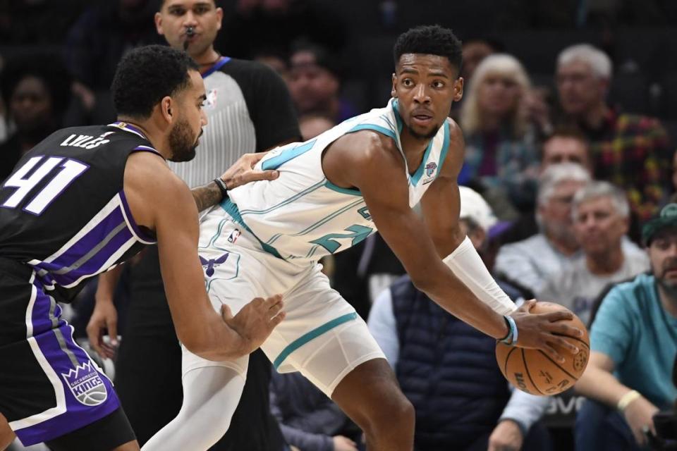 Charlotte Hornets forward Brandon Miller (24) looks to pass as he is defended by Sacramento Kings forward Trey Lyles (41) during the first half at the Spectrum Center.