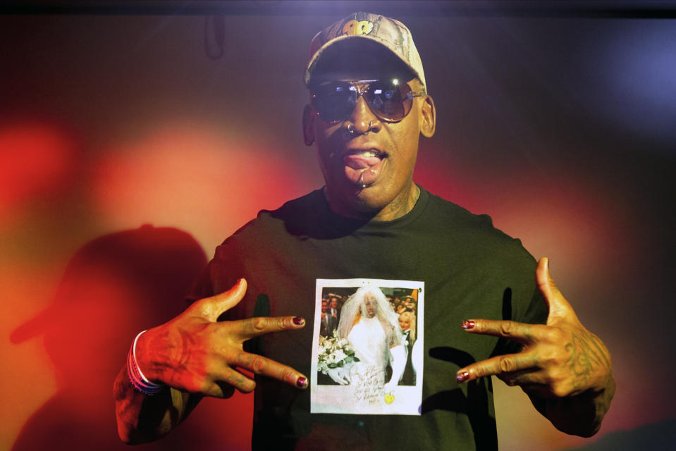 In this Monday, Sept. 9, 2019, photo, former NBA star Dennis Rodman poses wearing a T-shirt depicting himself in a wedding dress at a 1996 book promo event, in Los Angeles. After a career of spectacular highs and very public lows, Dennis Rodman keeps finding new ways to surprise. The former NBA star, featured in a new ESPN documentary, weighs in on his personal brand, bisexual athletes, North Korea and Trump. Rodman's spectacular personal highs and very public lows are the subject of the new ESPN "30 For 30" documentary "Dennis Rodman: For Better or Worse." (AP Photo/Damian Dovarganes)