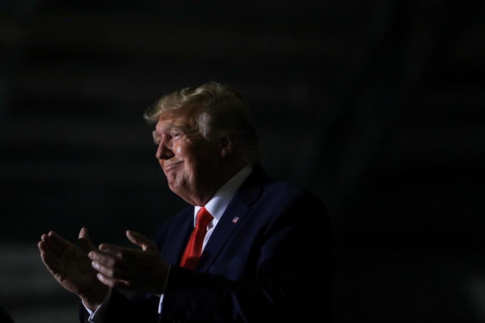 Former President Donald Trump claps as Michigan Secretary of State candidate Kristina Karamo speaks during a rally in Washington Township, Michigan, April 2, 2022. / Credit: EMILY ELCONIN / REUTERS