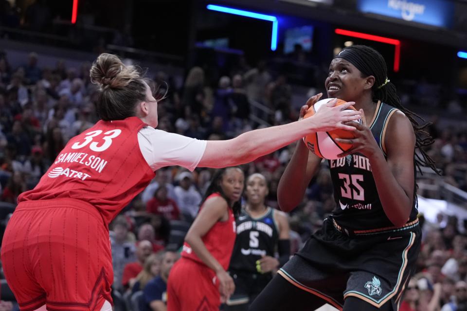 New York Liberty's Jonquel Jones (35) puts up a shot against Indiana Fever's Katie Lou Samuelson (33) during the first half of a WNBA basketball game, Saturday, July 6, 2024, in Indianapolis. (AP Photo/Darron Cummings)