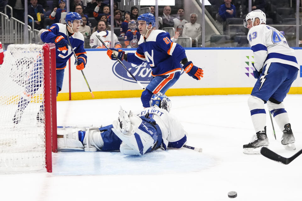 New York Islanders' Ryan Pulock (6) celebrates after Kyle Palmieri (21) scored a goal against Tampa Bay Lightning goaltender Brian Elliott during the second period of an NHL hockey game Thursday, April 6, 2023, in Elmont, N.Y. (AP Photo/Frank Franklin II)