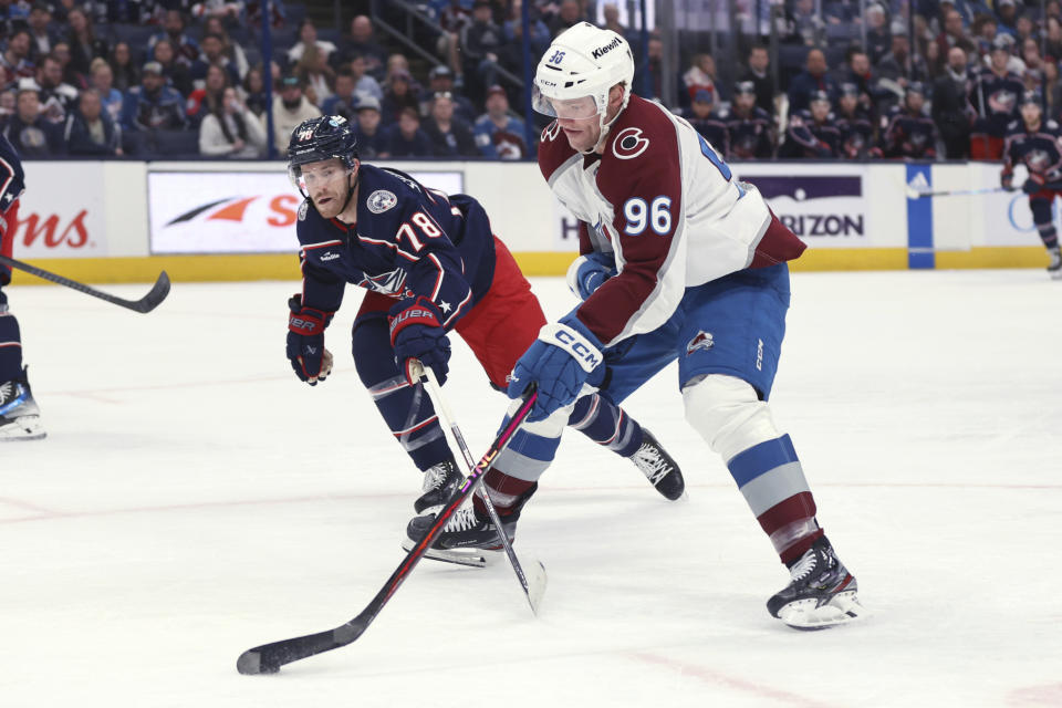 Colorado Avalanche forward Mikko Rantanen (96) controls the puck in front of Columbus Blue Jackets defenseman Damon Severson (78) during the first period of an NHL hockey game in Columbus, Ohio, Monday, April 1, 2024. (AP Photo/Paul Vernon)