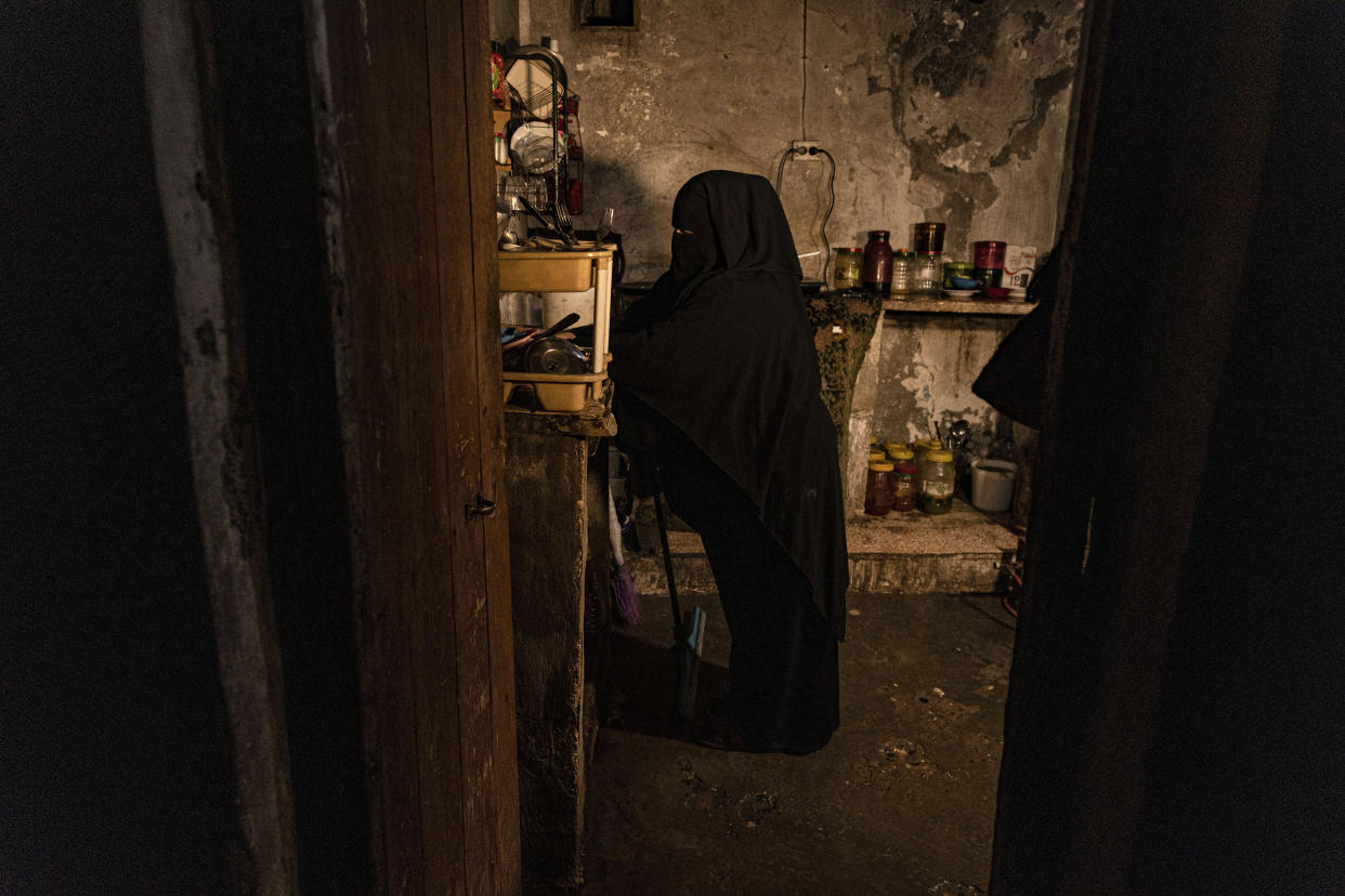 Marwa Ahmad stands in her kitchen in Raqqa, Syria, Wednesday, Dec. 28, 2022. Ahmad is among tens of thousands of widows and wives of IS militants who were detained in the wretched and lawless al-Hol camp in northeastern Syria after U.S.-led coalition and Syrian Kurdish forces cleared IS from northeastern Syria in 2019. (AP Photo/Baderkhan Ahmad)