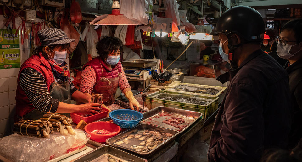 MACAU, CHINA - JANUARY 28: Residents wearing face masks purchase seafood at a wet market on January 28, 2020 in Macau, China. The number of cases of a deadly new coronavirus rose to over 4000 in mainland China Tuesday as health officials locked down the city of Wuhan last week in an effort to contain the spread of the pneumonia-like disease which medicals experts have confirmed can be passed from human to human. In an unprecedented move, Chinese authorities put travel restrictions on the city which is the epicentre of the virus and neighbouring municipalities affecting tens of millions of people.  At least six people have reportedly contracted the virus in Macau. The number of those who have died from the virus in China climbed to over 100 on Tuesday and cases have been reported in other countries including the United States, Canada, Australia, France, Thailand, Japan, Taiwan and South Korea.  (Photo by Anthony Kwan/Getty Images)