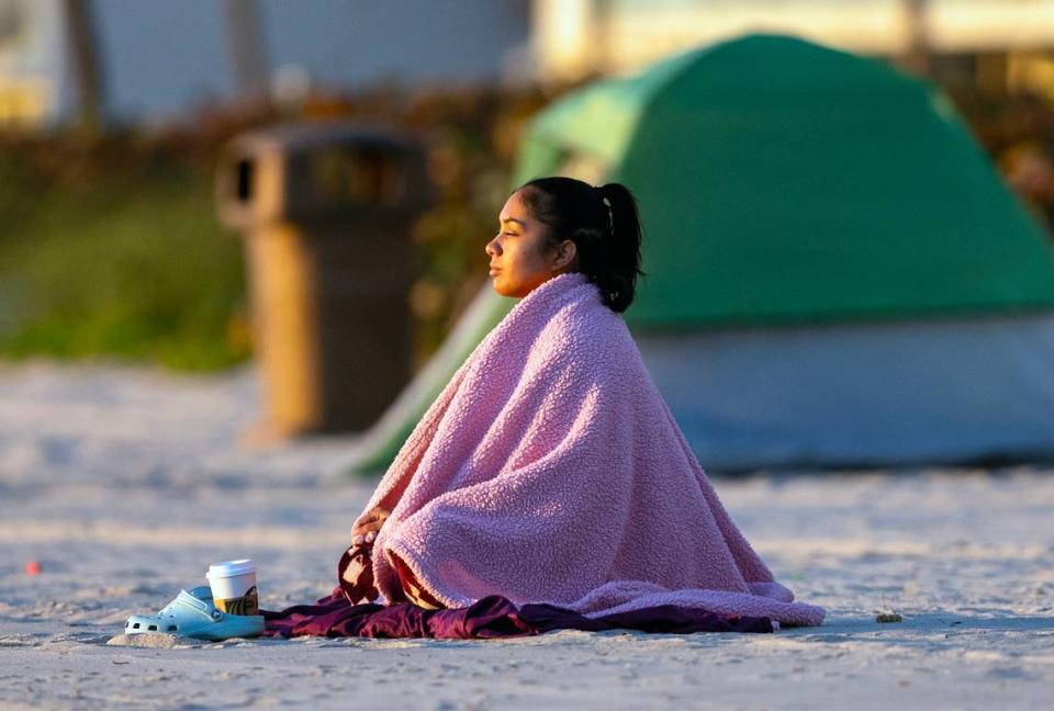 South Florida resident Lorraine Rodriguez taking in the sunrise under the cold weather on Tuesday, Jan. 30, 2024 in Sunny Isles Beach, Florida.