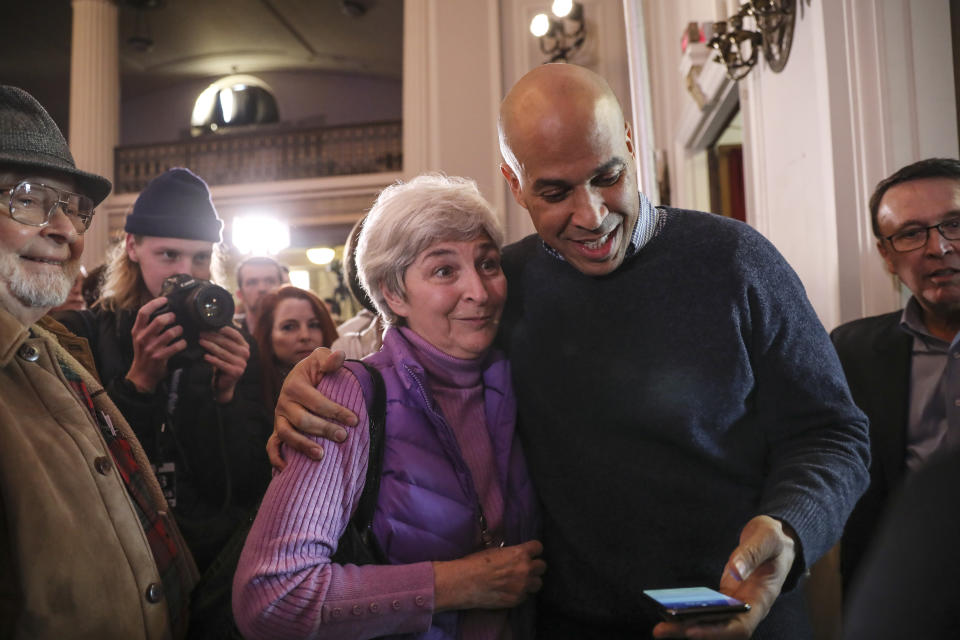 CORRECTS TO SATURDAY, NOT SUNDAY-U.S. Sen. Cory Booker, D-N.J., prepares to take a selfie with a supporter at a post-midterm election victory celebration in Manchester, N.H., on Saturday, Dec. 8, 2018. (AP Photo/Cheryl Senter)