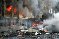 <p>Flames and smoke pour from a building at the Pentagon in Washington on Tuesday, Sept. 11, 2001. (AP Photo/Will Morris)</p> 