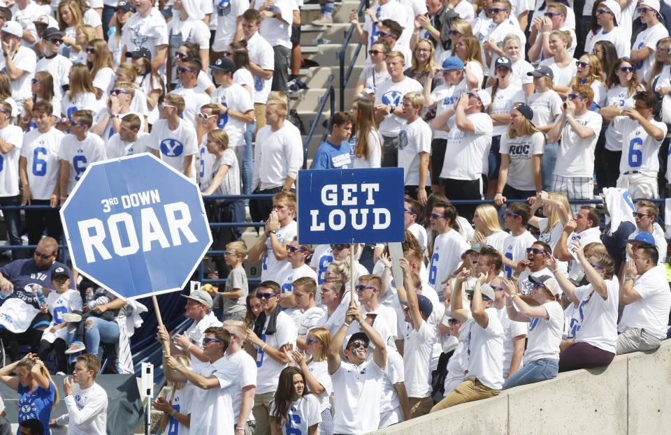 FILE - In this Sept. 16, 2017, file photo, BYU fans cheer in the first half during an NCAA college football game against Wisconsin, in Provo, Utah. The friendly confines of LaVell Edwards Stadium will have fans for the first time this season when No. 12 BYU faces Texas State on Saturday., Oct. 24, 2020. Cougars coach Kalani Sitake has a message for the approximately 6,000 who show up: Be loud. Be very, very loud. Make it seem like 60,000.(AP Photo/Kim Raff, File)