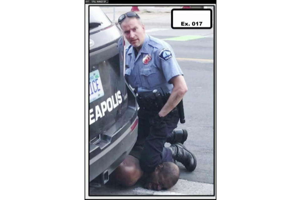 In this image from video provided by Darnella Frazier, Minneapolis Police Officer Derek Chauvin kneels on the neck of George Floyd in Minneapolis on Monday, May 25, 2020. The former Minneapolis police officer charged with killing Floyd went on trial Monday, March 29, 2021. For jurors at Chauvin's murder trial, the enduring image of the defendant is his impassive expression as he gazed at the teenager filming his knee pinning Floyd's neck – what the girl called his "cold" and "heartless" stare. (Darnella Frazier via AP)