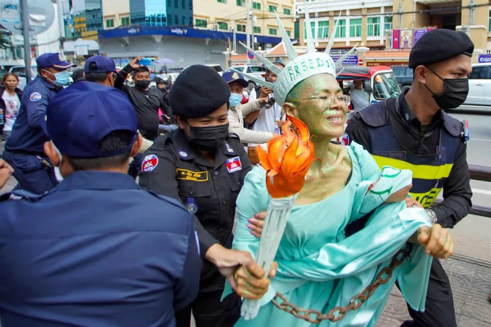 Cambodian-US human rights advocate Theary Seng, dressed as Lady Liberty, is arrested by police after being found guilty of treason in her trial in front of the Phnom Penh municipal court (AFP/Getty )