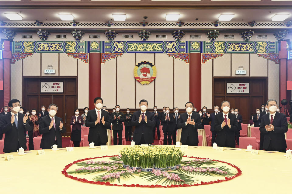 In this photo released by Xinhua News Agency Leaders of the Communist Party of China including Chinese President Xi Jinping, center and Chinese Premier Li Keqiang, third from right attend the New Year gathering organized by the National Committee of the Chinese People's Political Consultative Conference (CPPCC) in Beijing on Friday, Dec. 30, 2022. (Li Xueren/Xinhua via AP)