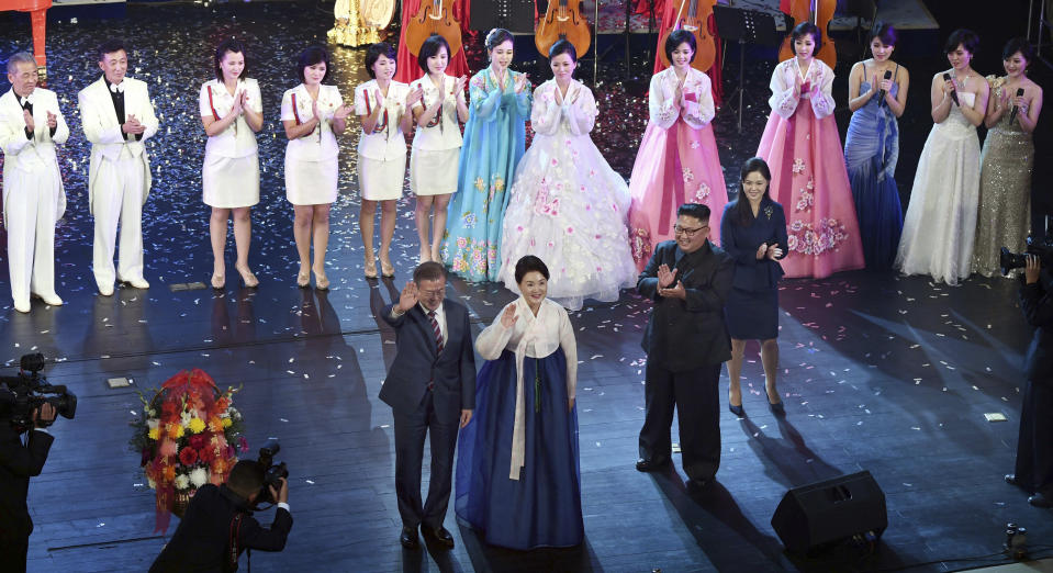 South Korean President Moon Jae-in, front left, and his wife Kim Jung-sook wave to the audience after watching an art performance as North Korean leader Kim Jong Un, bottom second from right, and his wife Ri Sol Ju look on at Pyongyang Grand Theatre in Pyongyang, North Korea, Tuesday, Sept. 18, 2018. (Pyongyang Press Corps Pool via AP)