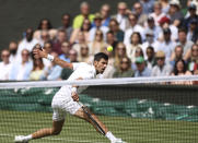 Serbia's Novak Djokovic plays a return to Italy's Matteo Berrettini during the men's singles final on day thirteen of the Wimbledon Tennis Championships in London, Sunday, July 11, 2021. (Steve Paston/Pool Via AP)