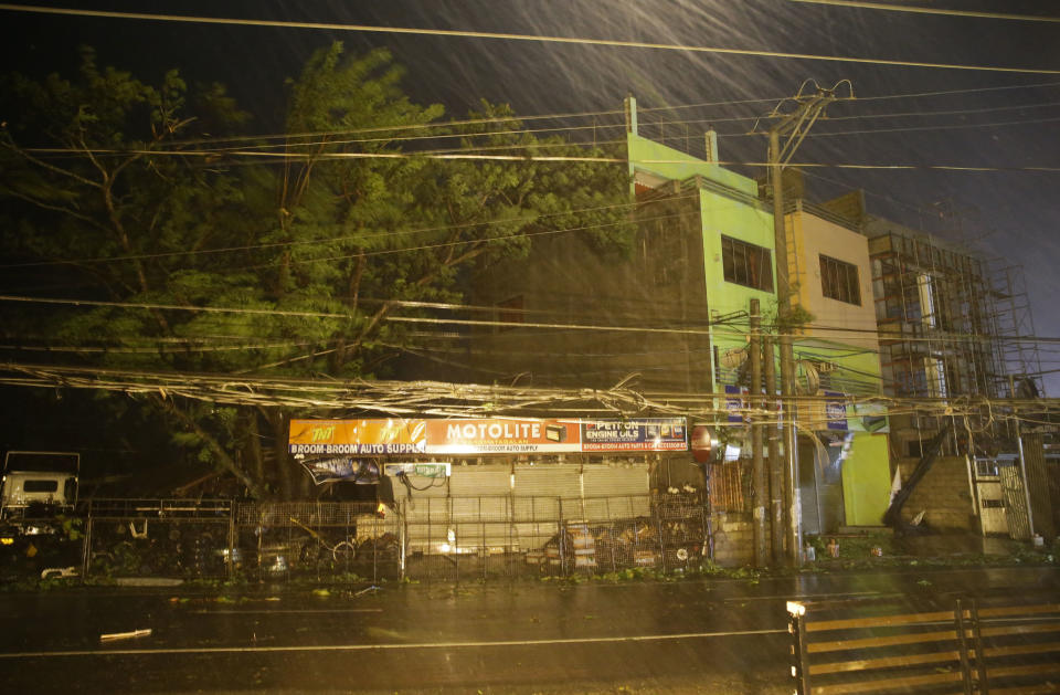 Strong winds and rain batter a town as Typhoon Mangkhut hits Tuguegarao city, Cagayan province, northeastern Philippines on Saturday, Sept. 15, 2018. Typhoon Mangkhut slammed into the country's northeastern coast early Saturday, with witnesses saying the storm's ferocious wind and blinding rain ripped off tin roof sheets and knocked out power at the start of the onslaught. (AP Photo/Aaron Favila)