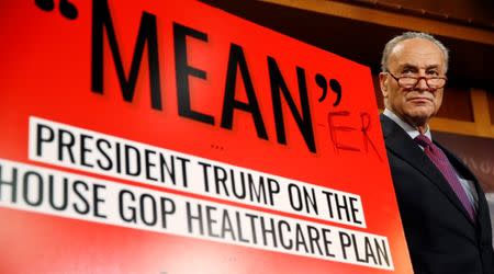 Senate Minority leader Chuck Schumer appears at a press conference with a sign that he had personally edited to read "Mean-er" after Senate Republicans unveiled their version of legislation that would replace Obamacare on Capitol Hill in Washington, U.S., June 22, 2017. REUTERS/Joshua Roberts
