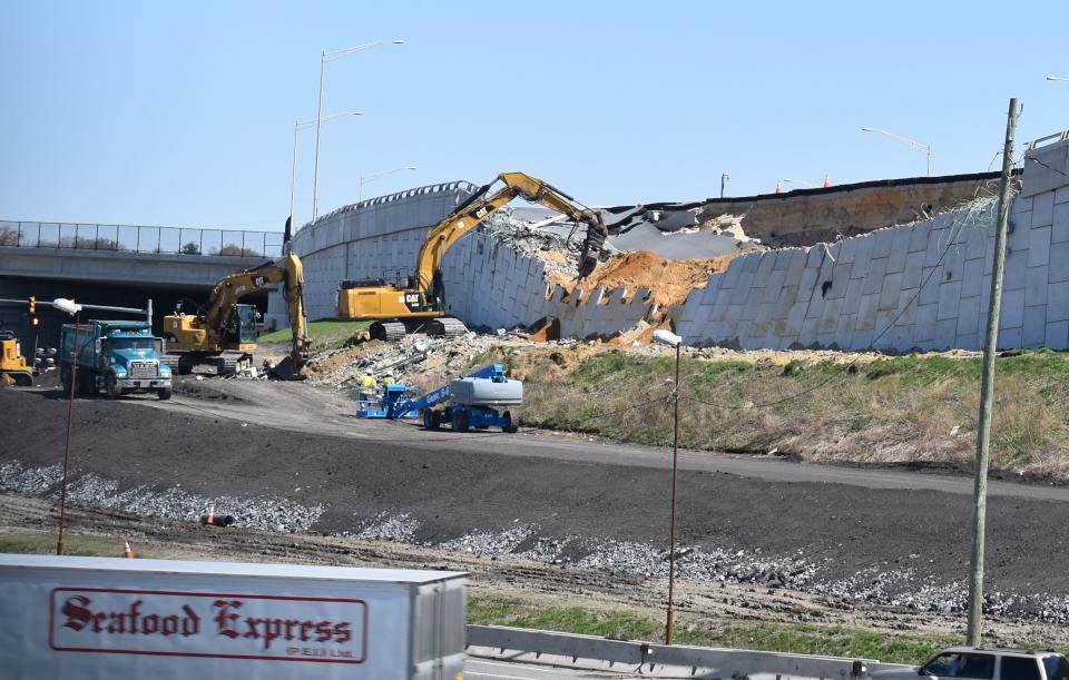 A demolition crew on April 6 tears down a failed retaining wall along Interstate 295 in Bellmawr.