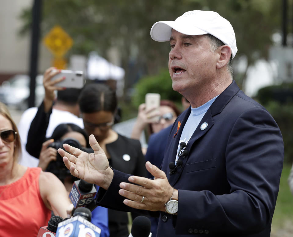 Florida Democratic gubernatorial candidate Philip Levine talks to members of the media Monday, Aug. 27, 2018, near the scene of a mass shooting at The Jacksonville Landing in Jacksonville, Fla. A gunman opened fire Sunday at a video game tournament killing multiple people and then fatally shooting himself in a rampage that wounded several others. (AP Photo/John Raoux)