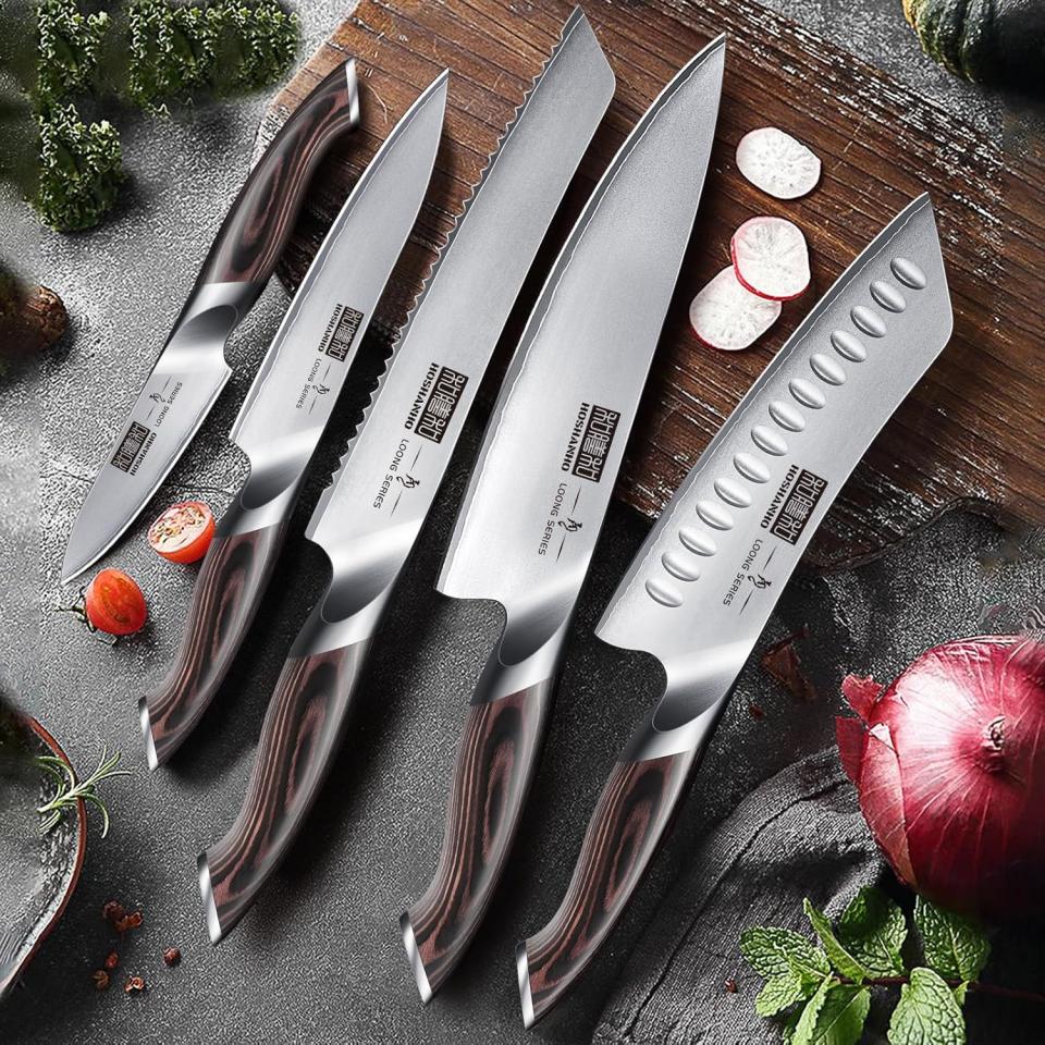 the knife set from Amazon on a counter and resting on a cutting board