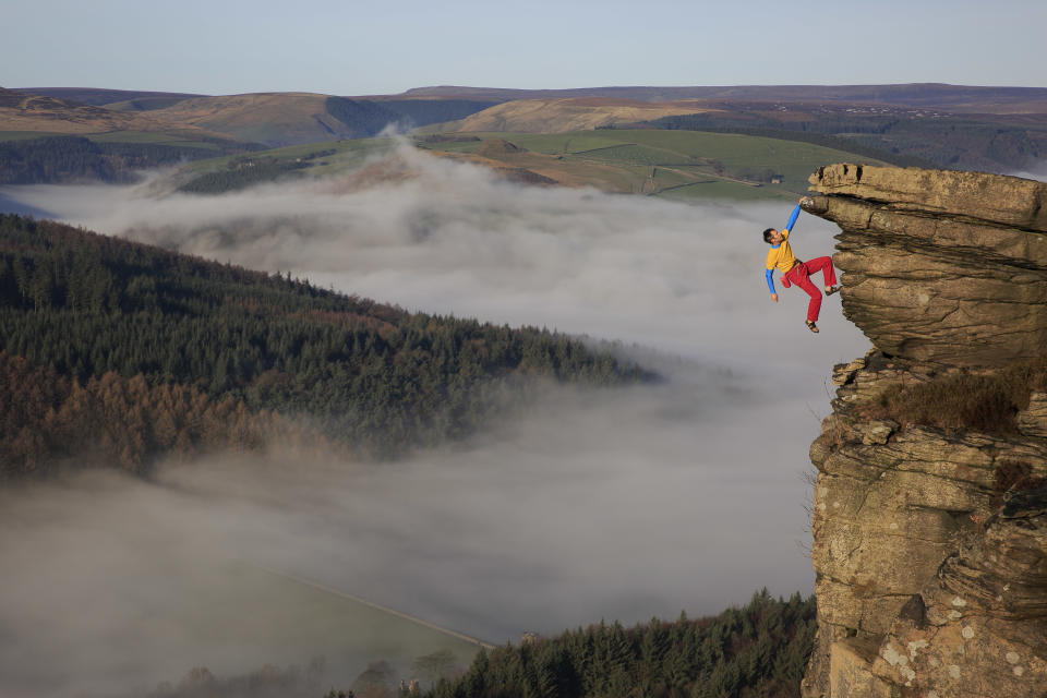 Mike Hutton hangs from Gargoyle Flake in the Peak District in England. (Photo: Mike Hutton/Caters News)