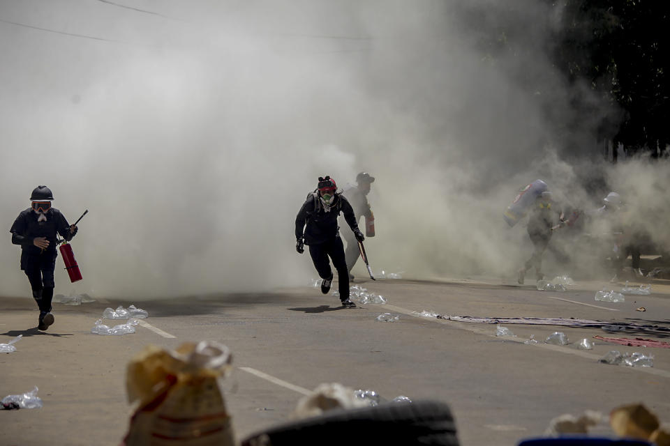 Anti-coup protesters discharge fire extinguishers to counter the impact of the tear gas fired by police during a demonstration in Yangon, Myanmar Thursday, March 4, 2021. Demonstrators in Myanmar protesting last month's military coup returned to the streets Thursday, undaunted by the killing of at least 38 people the previous day by security forces. (AP Photo)