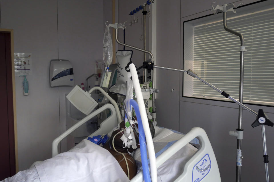 A patient affected by COVID-19 virus in the ICU unit at the Ambroise Pare clinic in Neuilly-sur-Seine, near Paris, Friday, March 19, 2021. French Prime Minister Jean Castex announced new coronavirus restrictions as the number of COVID-19 patients in intensive care units spikes. (AP Photo/Thibault Camus)