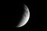 A shadow falls on the moon as it undergoes a total lunar eclipse as seen from Mexico City April 15, 2014. (REUTERS/Edgard Garrido)