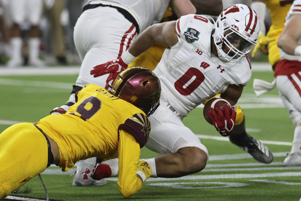 Arizona State linebacker Eric Gentry (9) tackles Wisconsin running back Braelon Allen (0) during the second half of the Las Vegas Bowl NCAA college football game Thursday, Dec. 30, 2021, in Las Vegas. (AP Photo/L.E. Baskow)