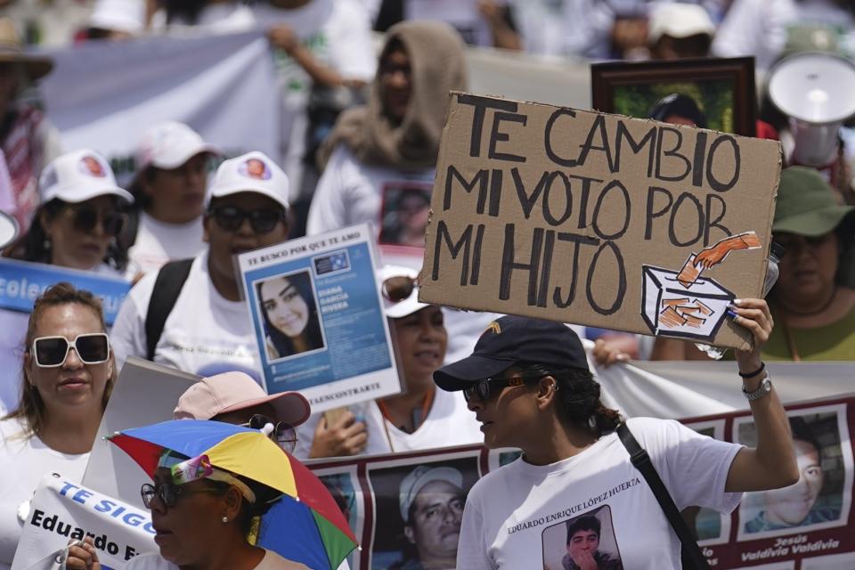 People attend the annual National March of Searching Mothers, held every Mother's Day in Mexico City, Friday, May 10, 2024. The marchers say the government’s lack of interest in investigating the disappearances of Mexico’s over 100,000 missing people. The sign reads in Spanish "I'll exchange my vote for my son," referring to this year's presidential election. (AP Photo/Marco Ugarte)