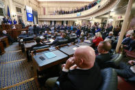 FILE - This Wednesday, Jan. 8, 2020 file photo shows House Republicans as they sit in their sets while Democratic lawmakers applaud Virginia Gov. Ralph Northam as he delivers his State of the Commonwealth address before a joint session of the Virginia Assembly at the Virginia state Capitol in Richmond, Va. Northam was talking about his gun control legislation. (AP Photo/Steve Helber)