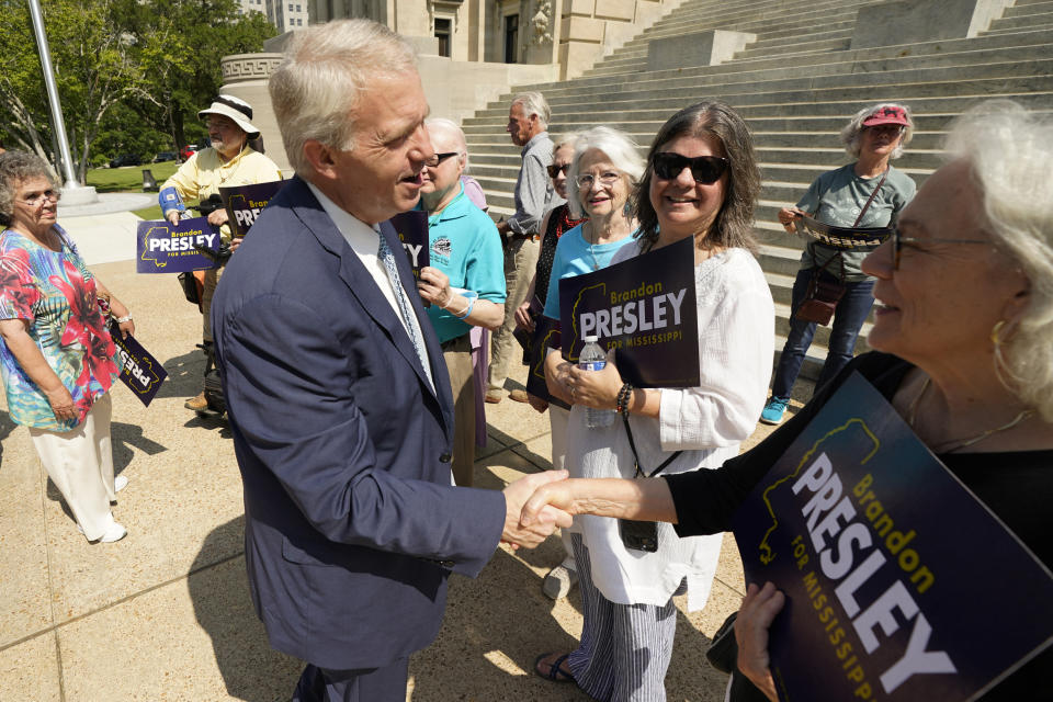 Brandon Presley shakes hands with supporters on the steps of the Capitol.